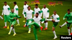 Preparing to play Germany, Algeria's Rafik Halliche, center, and teammates train at the Arena do Gremio in Porto Alegre, Brazil, June 29, 2014. 