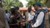 ARCHIVES - Tedros Adhanom, directeur général de l'OMS, discute avec des habitants du village d’Itipo, dans la province de l’Equateur, RDC, 12 juin 2018. 