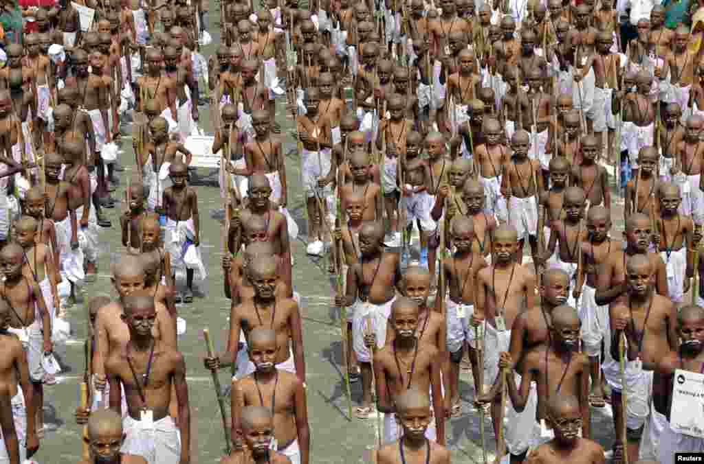School children dressed as Mahatma Gandhi assemble to mark his death anniversary in the southern Indian city of Chennai. 