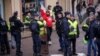 Protesters of the 'Gilets Jaunes' (Yellow Vests) movement await French President Emmanuel Macron's arrival, during his meeting with the mayors of the Saone-et-Loire department, in Autun, France Feb. 7, 2019. 