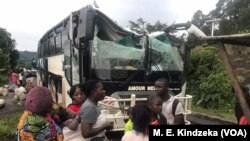 A bus attacked by armed separatist and its passengers are seen at Akum, a village 10 Kilometers from Bamenda, the capital of the Cameroon's English speaking northwest region, Sept. 9, 2018.