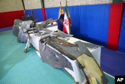 Debris from what Iran's Revolutionary Guard aerospace division describes as the U.S. drone which was shot down on Thursday is displayed in Tehran, Iran, Friday, June 21, 2019. (Meghdad Madadi/ Tasnim News Agency via AP)