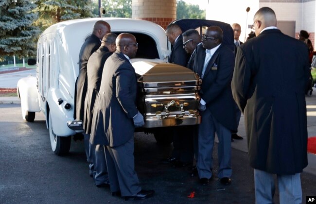 Pallbearers carry the gold casket of legendary singer Aretha Franklin after arriving at the Greater Grace Temple in Detroit, Aug. 31, 2018.