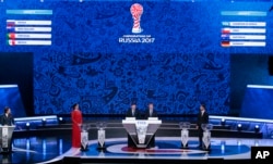 Former Russian pole vaulter Yelena Isinbayeva, Zvonimir Boban, FIFA's Deputy Secretary General, Colin Smith, FIFA's director of competition, and former Russian soccer player Sergei Semak, from left, take part in the draw for Confederations Cup 2017.