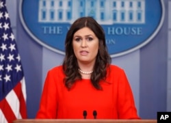 FILE - White House press secretary Sarah Huckabee Sanders speaks to members of the media.