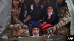 Pakistani soldiers transport rescued school children from the site of an attack by Taliban gunmen on a school in Peshawar, Dec. 16, 2014. 