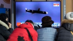 People watch a TV showing a file image of North Korea's missile launch during a news program at the Seoul Railway Station in Seoul, South Korea, Jan. 25, 2022.
