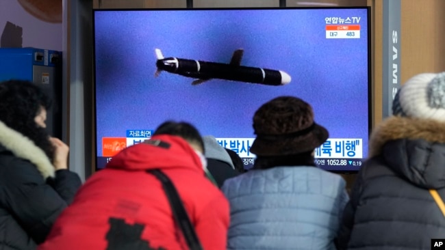 People watch a TV showing a file image of North Korea's missile launch during a news program at the Seoul Railway Station in Seoul, South Korea, Jan. 25, 2022.