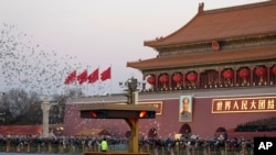 Pigeons are released during the first flag raising ceremony of the year with the Guard of Honor of the Chinese People's Liberation Army taking over the ceremonial duty from the Paramilitary police in Beijing, China, Monday, Jan. 1, 2018. (AP Photo)