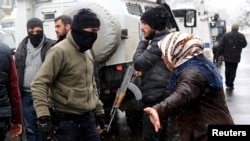 A Kurdish demonstrator argues with members of Turkish police special forces during a protest against the curfew in Sur district and security operations in the region, in the southeastern city of Diyarbakir, Turkey December 31, 2015.