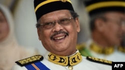 FILE - Malaysia's Attorney-General Mohamed Apandi Ali smiles as he arrives for the Warriors' Day Celebration in Putrajaya, outside Kuala Lumpur on July 31, 2016.
