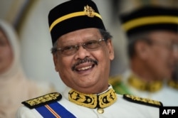 FILE - Malaysia's Attorney-General Mohamed Apandi Ali smiles as he arrives for the Warriors' Day Celebration in Putrajaya, outside Kuala Lumpur on July 31, 2016.