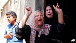 Palestinian relatives of Haitham Mishal, 29, react during his funeral in the Shati Refugee Camp in Gaza City, April 30, 2013.
