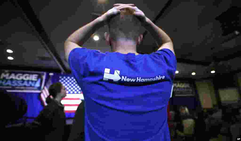 Matt Sanborn of Laconia, N.H., a Boston College student who volunteered for Democratic candidates including Hillary Clinton and New Hampshire Democratic Senate candidate, Gov. Maggie Hassan, rests his hands on the top of his head while watching election r