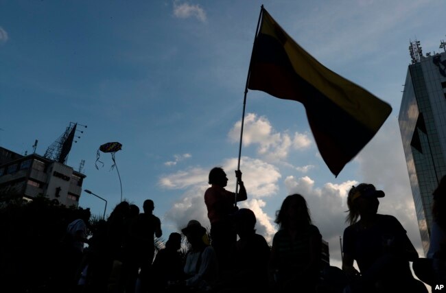 Opponents to Venezuela's President Nicolas Maduro hold a vigil for those killed in street fighting over the past week in Caracas, Venezuela, May 5, 2019.