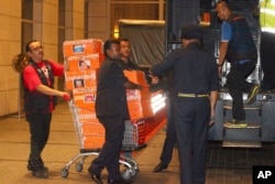 FILE - Police prepare to load confiscated items into a truck in Kuala Lumpur, May 18, 2018.