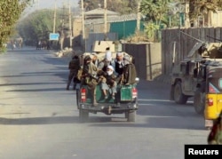 Afghan Local Police (ALP) forces sit on the back of a police pickup in Kunduz city, Afghanistan, Oct. 4, 2016.