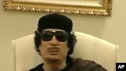 Muammar Gaddafi gestures as he speaks at a Tripoli hotel in this still image from a video by Libyan TV released May 11, 2011.