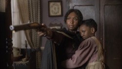 This image released by Focus Features shows Cynthia Erivo as Harriet Tubman, left, and Aria Brooks as Anger in a scene from "Harriet."