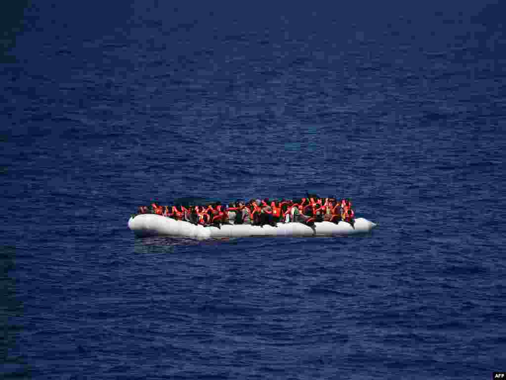 Refugees wait to be rescued during an operation at sea with the Aquarius, a former North Atlantic fisheries protection ship now used by humanitarians SOS Mediterranee and Medecins Sans Frontieres (Doctors without Borders), in the Mediterranean sea not far from the Libyan coast.