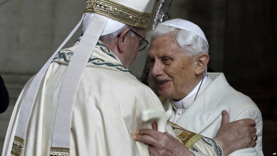 FILE - Pope Emeritus Benedict XVI, right, hugs Pope Francis in St. Peter's Basilica during a ceremony at the Vatican, Dec. 8, 2015. Benedict resigned from the papacy due to poor health in 2013; questions are being raised in 2025 as Francis remains hospitalized for a fourth week.