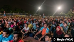 A crowd of opposition supporters wait as results are announced from the Malaysian election, May 9, 2018.