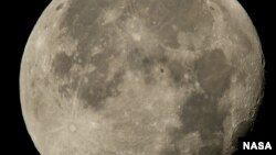 FILE - The International Space Station, with a crew of six onboard, is seen in silhouette as it transits the moon at roughly five miles per second, Sunday, Aug. 2, 2015, Woodford, VA. 