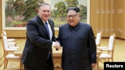 North Korean leader Kim Jong Un shakes hands with U.S. Secretary of State Mike Pompeo, May 9, 2018, released by North Korea's Korean Central News Agency (KCNA) in Pyongyang.