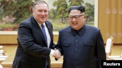FILE - North Korean leader Kim Jong Un shakes hands with U.S. Secretary of State Mike Pompeo, May 9, 2018, released by North Korea's Korean Central News Agency in Pyongyang.