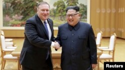 North Korean leader Kim Jong Un shakes hands with U.S. Secretary of State Mike Pompeo, May 9, 2018, released by North Korea's Korean Central News Agency (KCNA) in Pyongyang.