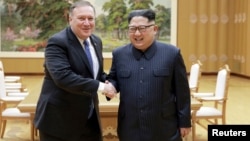 North Korean leader Kim Jong Un shakes hands with U.S. Secretary of State Mike Pompeo, May 9, 2018, released by North Korea's Korean Central News Agency (KCNA) in Pyongyang.