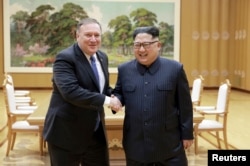 FILE - North Korean leader Kim Jong Un shakes hands with U.S. Secretary of State Mike Pompeo, May 9, 2018, released by North Korea's Korean Central News Agency (KCNA) in Pyongyang.