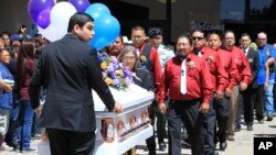 Pallbearers escort the casket of 11-year-old Ashlynne Mike out of the Civic Center following a memorial service, in Farmington, N.M.,May 6, 2016. Thousands of people from surrounding communities gathered at the center and along the procession route in sup