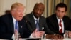 FILE - President Donald Trump, left, speaks during a meeting with manufacturing executives at the White House in Washington, including Merck CEO Kenneth Frazier, center, and Ford CEO Mark Fields, Feb. 23, 2017. 