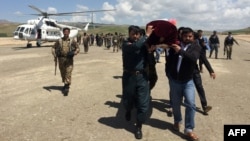 FILE - Relatives carry the coffin of an Afghan National Army soldier killed in a Taliban attack in Takhar province, Afghanistan, April 23, 2017. On Thursday, a Taliban raid in Takhar province killed 16 Afghan forces.