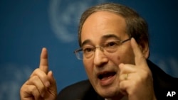 Syrian Deputy Foreign Minister Faisal Makdad gestures during a press briefing at the United Nations headquarters in Geneva, Switzerland, Jan. 26, 2014.