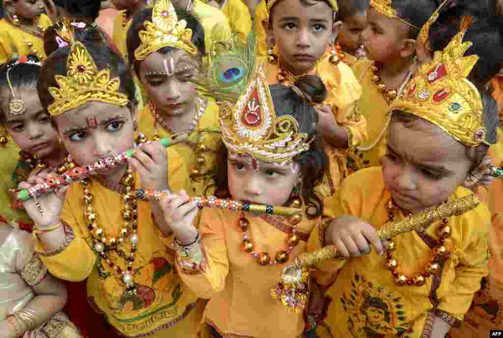 Schoolchildren dressed up as Hindu deity Krishna perform during celebrations on the eve of the Janmashtami festival that marks Krishna&#39;s birthday, in Amritsar.