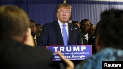 FILE - U.S. Republican presidential candidate Donald Trump, surrounded by members of Atlanta's black clergy, speaks at a news conference in Norcross, Georgia, Oct. 10, 2015.