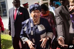 FILE - Sierra Leone President, Ernest Bai Koroma, left, and Liberia President, Ellen Johnson Sirleaf, right, on arrival for talks with President Yahya Jammeh, in Banjul, Gambia.