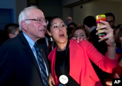 FILE - Democratic presidential candidate Sen. Bernie Sanders, I-Vt. poses for photos after he spoke at Congressional Hispanic Caucus Institute Public Policy Conference at Washington Convention Center in Washington, Oct. 7, 2015.