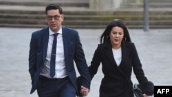 FILE - Former footballer and victim of abuse Andy Woodward (L) arrives at court with his partner Zelda in Liverpool on Jan. 8, 2018 on the first day of the trial of former football coach Barry Bennell.