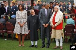 U.S. President Barack Obama, second right and first lady Michelle Obama, left stand with Indian Prime Minister Narendra Modi, right and Indian President Pranab Mukherjee during a photo op at a reception hosted by Mukherjee on India’s Republic Day.