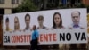 A man walks past a banner which reads "The Constituent Assembly will not happen," in Caracas, Venezuela, July 24, 2017. Pictured on the banner are opposition leaders.