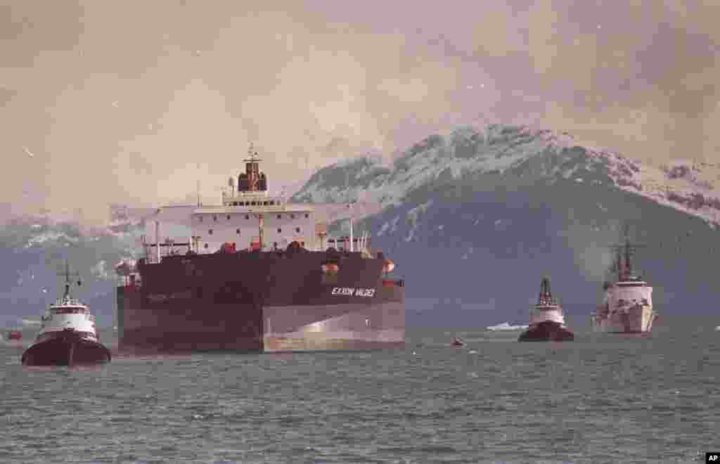 FILE - The Exxon Valdez is pictured being towed out of Prince William Sound in Alaska by a tug boat and a U.S. Coast Guard Cutter, June 23, 1989.