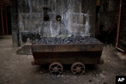 FILE - An old wagon filled with coal remains at the Rhondda Heritage Park, the former Lewis Menthyr Colliery in Pontypridd, Wales, June 30, 2016. Britain’s last deep coal mine closed in 2015.