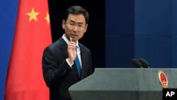 FILE - Chinese Foreign Ministry spokesman Geng Shuang speaks during a daily briefing at the Ministry of Foreign Affairs office in Beijing, Sept. 4, 2017. 