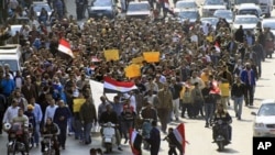 Anti-government protesters march through a street in Cairo, Egypt. Egypt's military threw its weight Friday behind President Hosni Mubarak's plan to stay in office through September elections, February 11, 2011.
