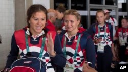 Members of the Russian Olympic delegation line up to board a bus after arriving at the Rio de Janeiro International Airport July 29, 2016, to compete at the 2016 Summer Olympics in Rio de Janeiro, Brazil.