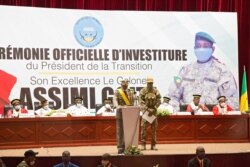 FILE - New interim Malian President, Colonel Assimi Goita (C-L), addresses the nation during his swearing in ceremony in Bamako, June 7, 2021.