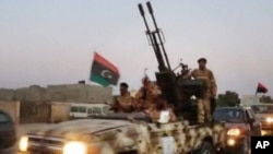 Various army special forces trucks arrive at scene after fighting broke out near offices of the Libya Shield pro-government militia, Benghazi, Libya, June 8, 2013.